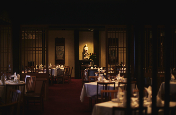 The moody, darkly lit interior of Flower Drum restaurant.