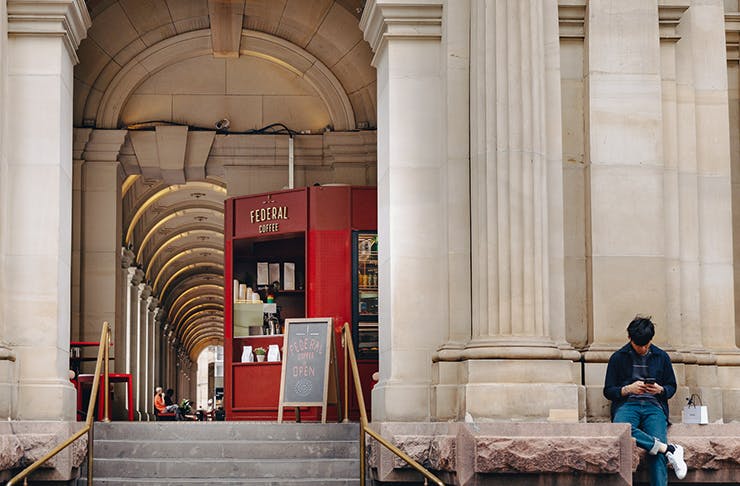 A coffee stand set within the large concrete pillars of Melbourne's GPO building.