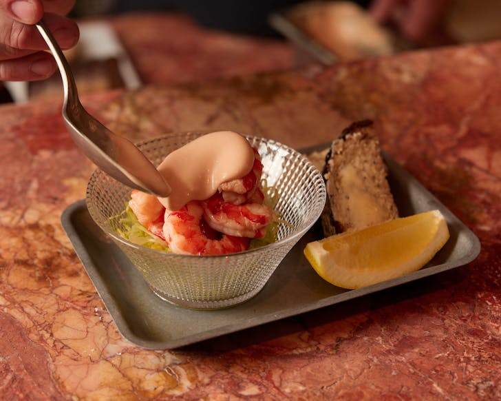 a classic prawn cocktail being plated at manly restaurant felons seafood
