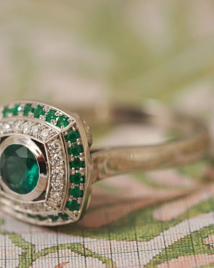 Platinum ring set with central 0.67ct Emerald with 0.15ct round brilliants TDW and 0.26ct in grain set surround from Filigree, one of the best jewellers in NZ.