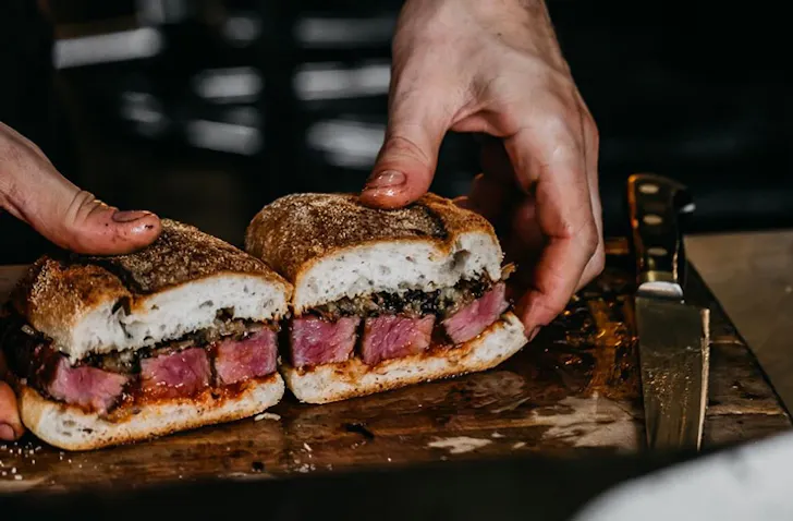 A sandwich from Firedoor, featuring its famous smoked meats. 