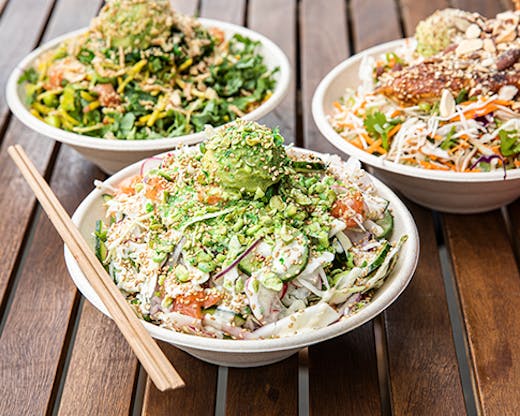 A healthy salad bowl filled with greens and fish.