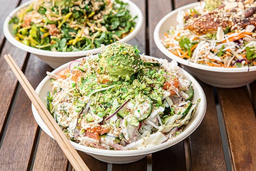 A healthy salad bowl filled with greens and fish.