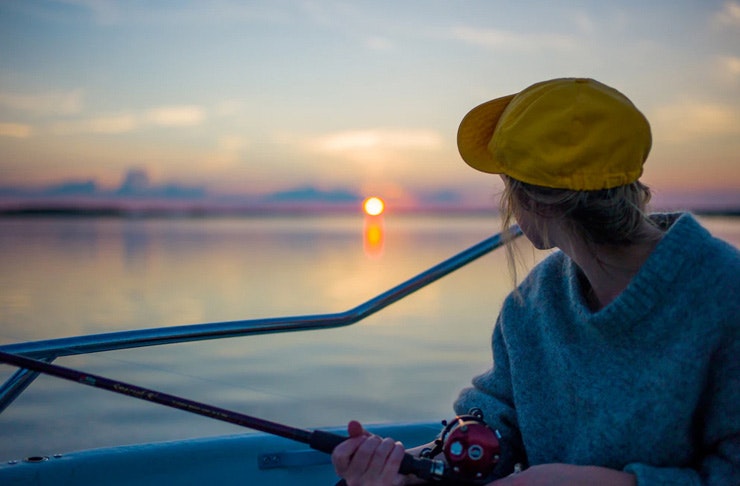 A girl holds a fishing rod
