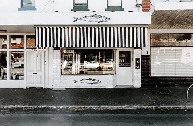 The white and black exterior of a fishmonger.