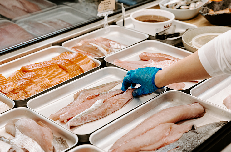 fresh cuts of fish in display fridge.