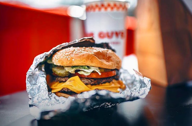 A shot of a Five Guys burger wrapped in foil. 