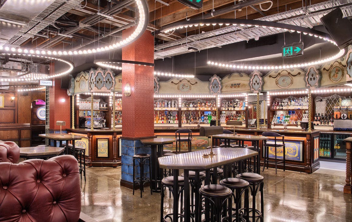 inside the new Flight Club Perth, with a vintage British fairground fitout