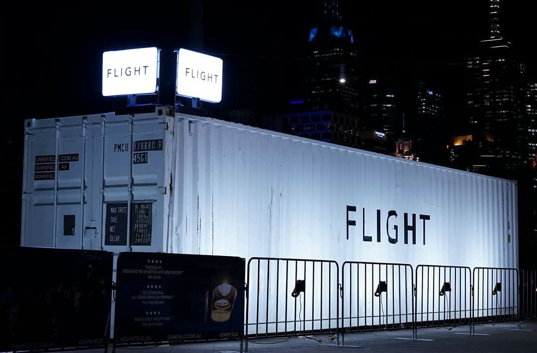 White shipping container with the word FLIGHT on the side