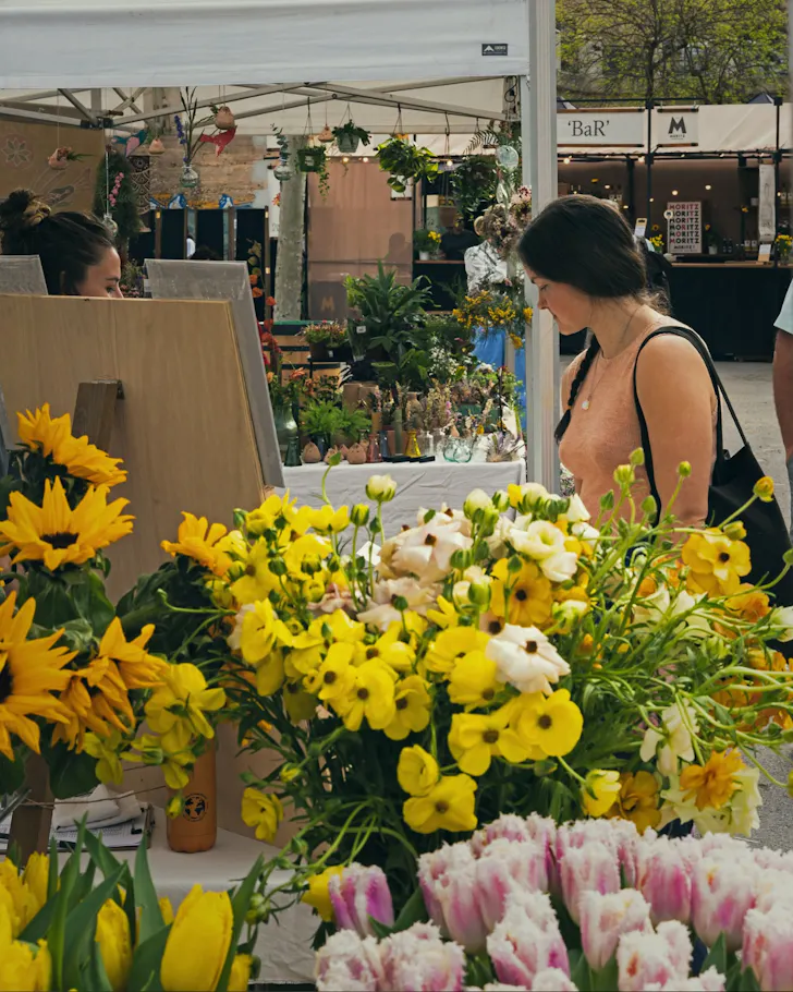 Yellow and pink flowers on display in a stall at the flower markets in Barcelona.