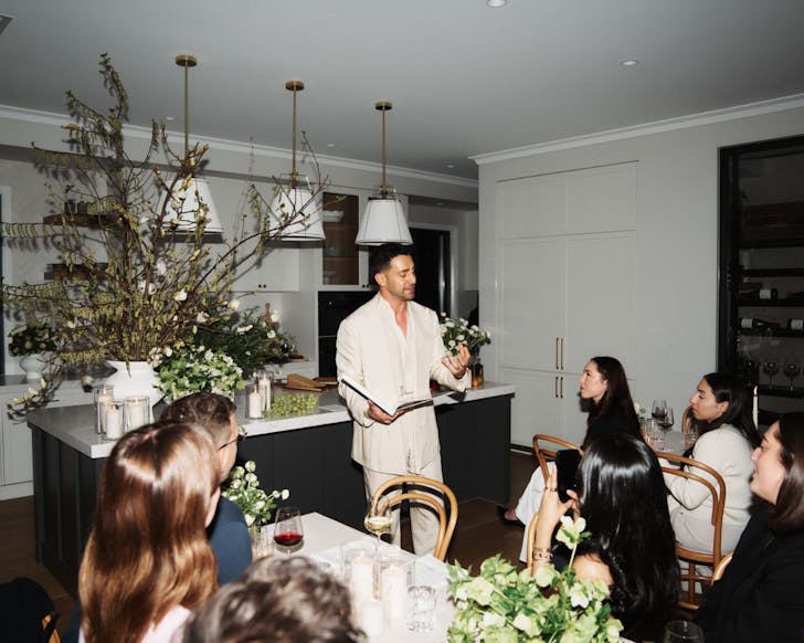 A man speaks to a group of people about interior design