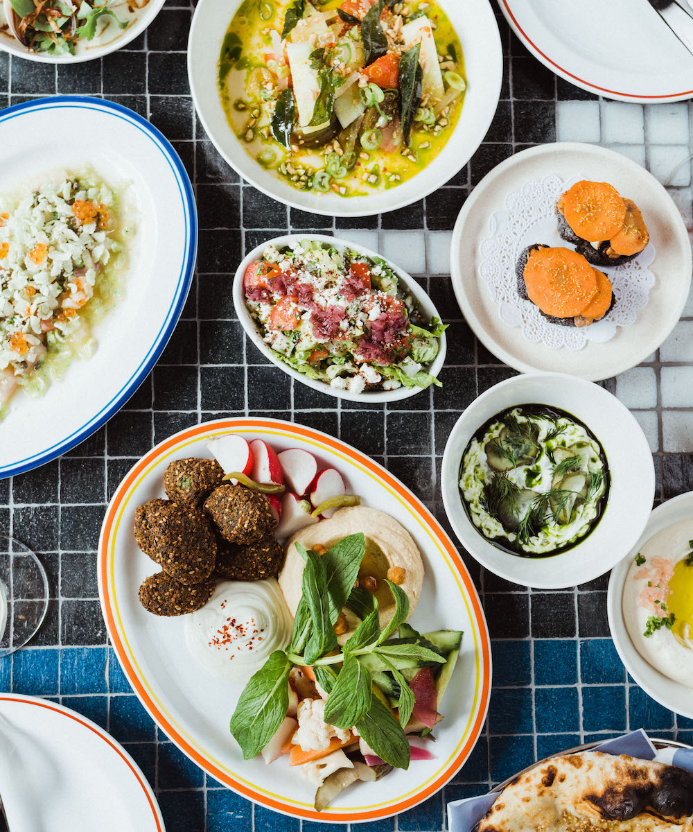 a view from above a tiled table full of bright share plates