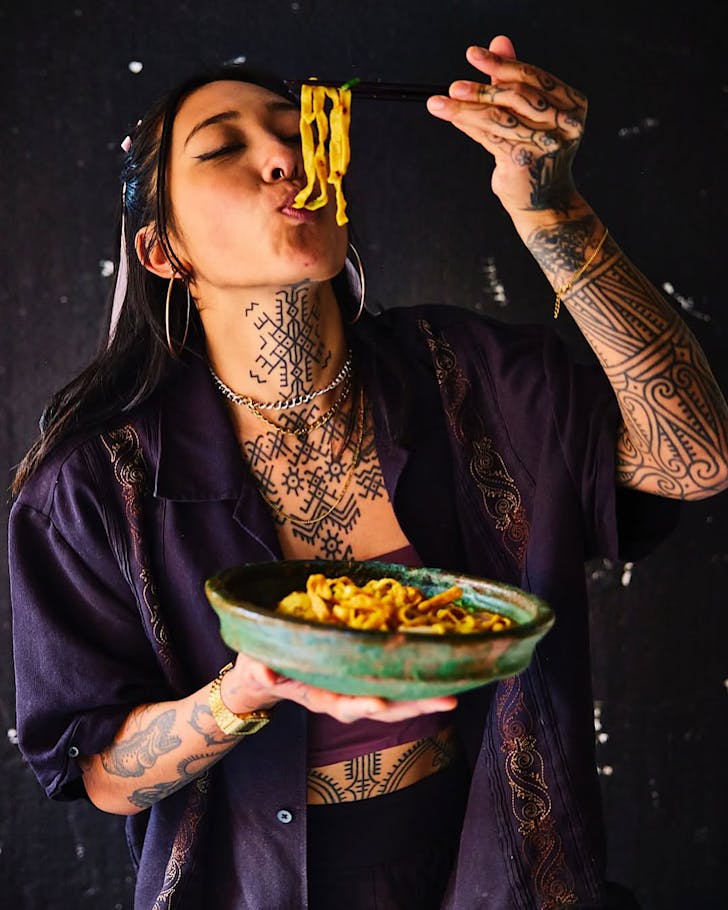 Masterchef Australia 2024 winner Nat Thaipun chows down a fresh bowl of noodles with chopsticks.