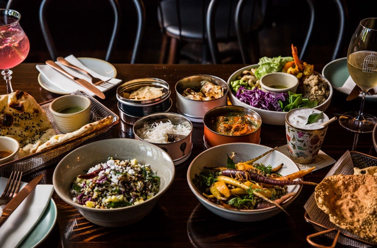 Bowls of curry, naan, and more from Foreign Return restaurant. 