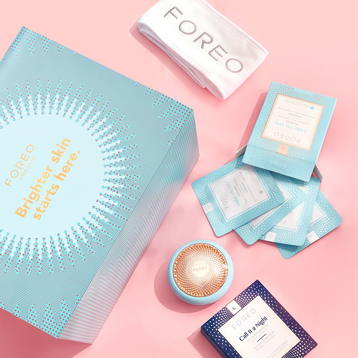 a small foreo light device and several different sheet mask packets