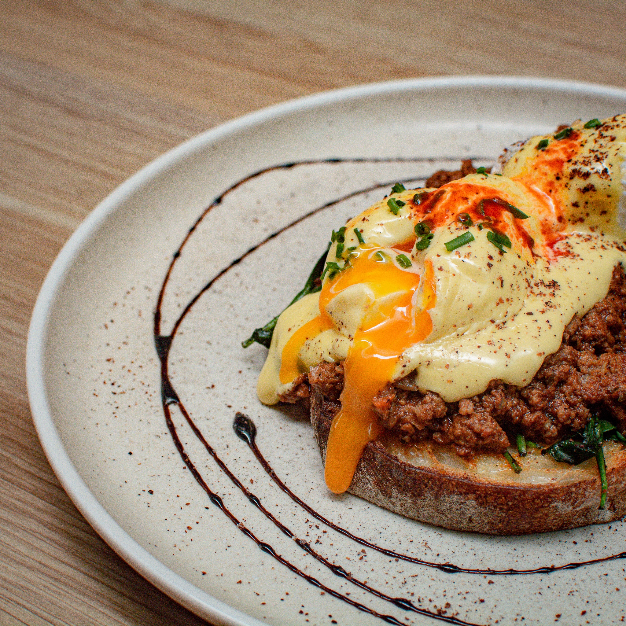 a plate of savoury mince on toast with poached egg
