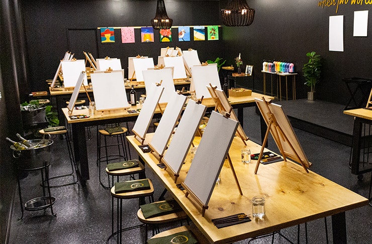 a paint-and-sip studio with black walls