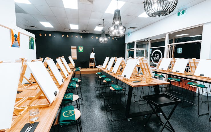 Inside of Frida's studio, with easels lining tables 
