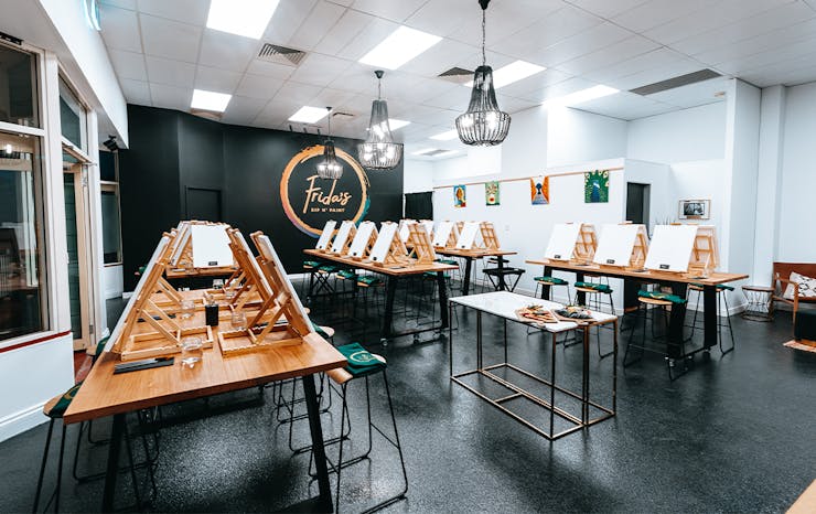 Inside of Frida's studio, with easels lining tables 