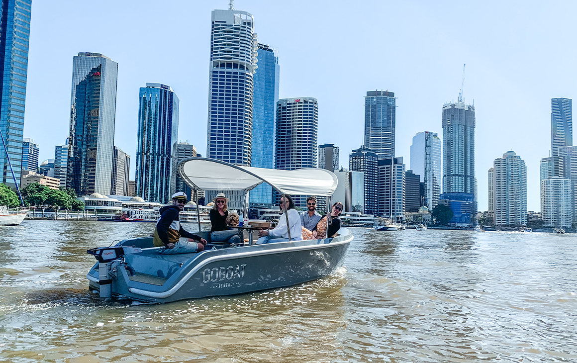 a group of people in a small boat on the river