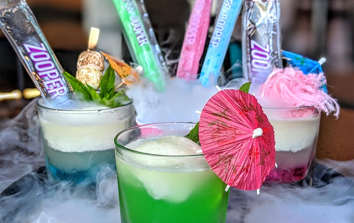 three cocktails in short glasses on a tray with Zooper Doopers in them