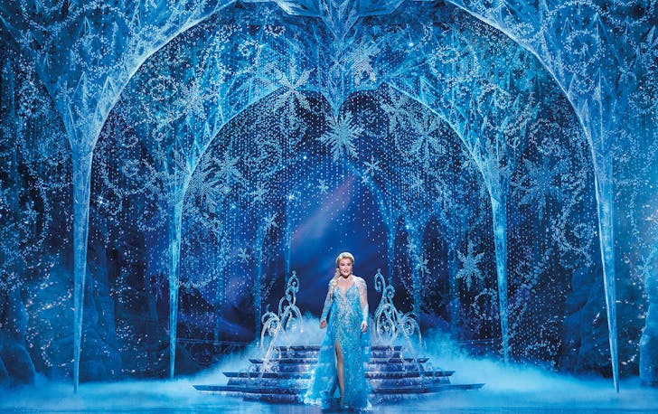 a woman on stage dressed as Elsa from Disney's Frozen