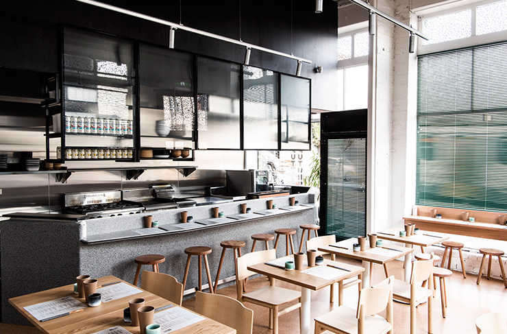 A minimal-style dining room with an open kitchen at one of the best restaurants in Richmond.