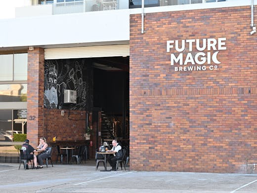 the front entrance of future magic, with a large brick wall
