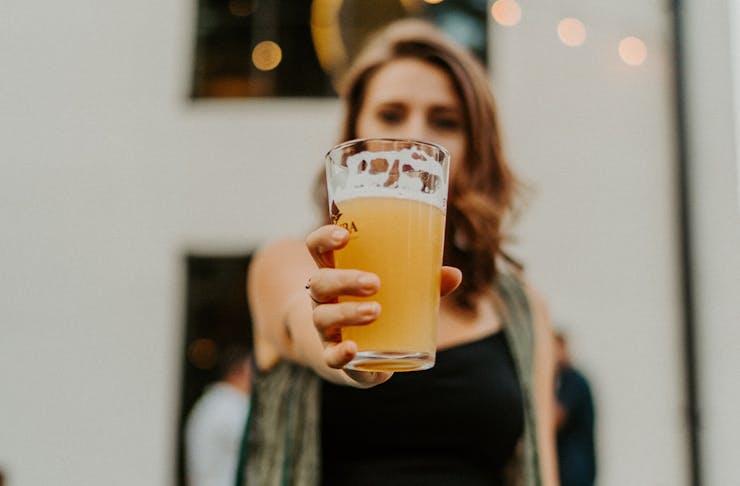 a woman holding a beer