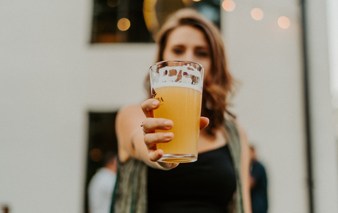 a woman holding a beer