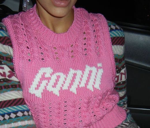 A person in a pink GANNI vest, which you can shop at the Ganni boutique in Sydney. 