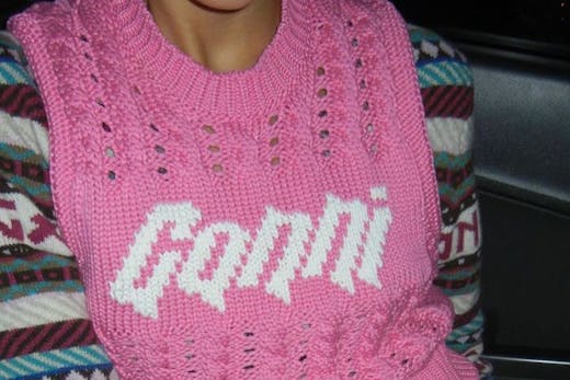 A person in a pink GANNI vest, which you can shop at the Ganni boutique in Sydney.