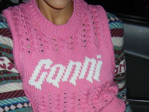 A person in a pink GANNI vest, which you can shop at the Ganni boutique in Sydney. 