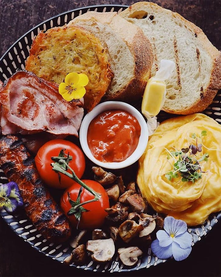 A heaping full English breakfast fills the plate at Gather Cafe, one of the best cafes in Tauranga.