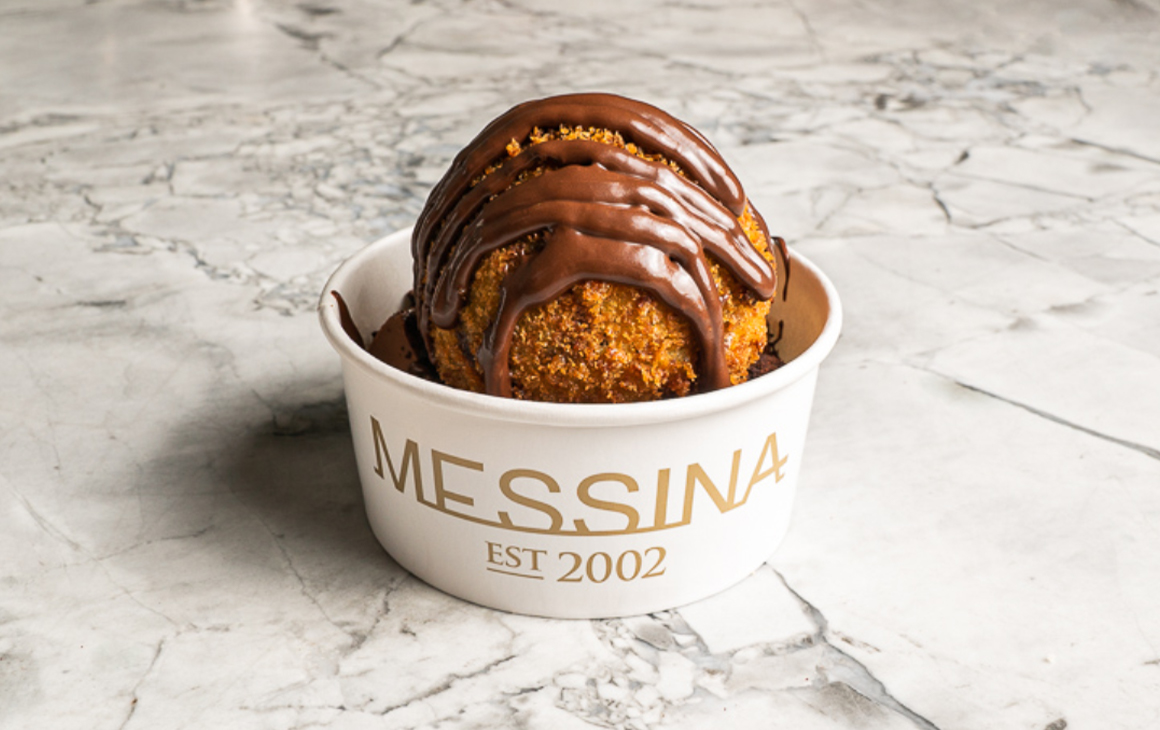 A perfectly round scoop of ice cream topped with chocolate at one of the best gelato shops in Melbourne, Messina.