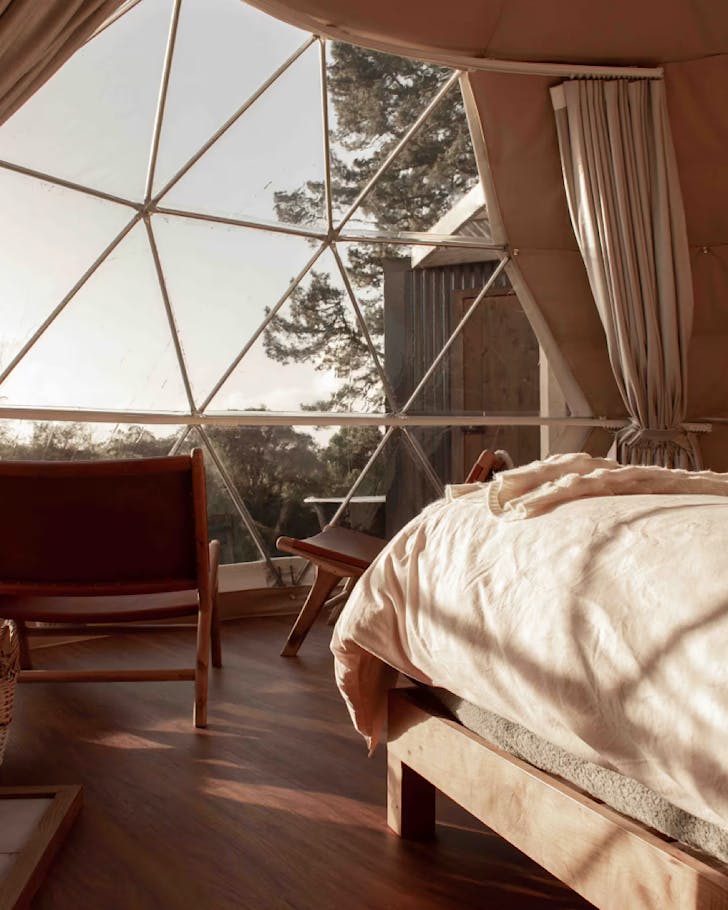 The soft-lighted, comfortable interior of a luxury geodesic dome.