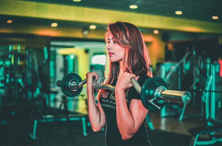 A woman lifting weights at the gym