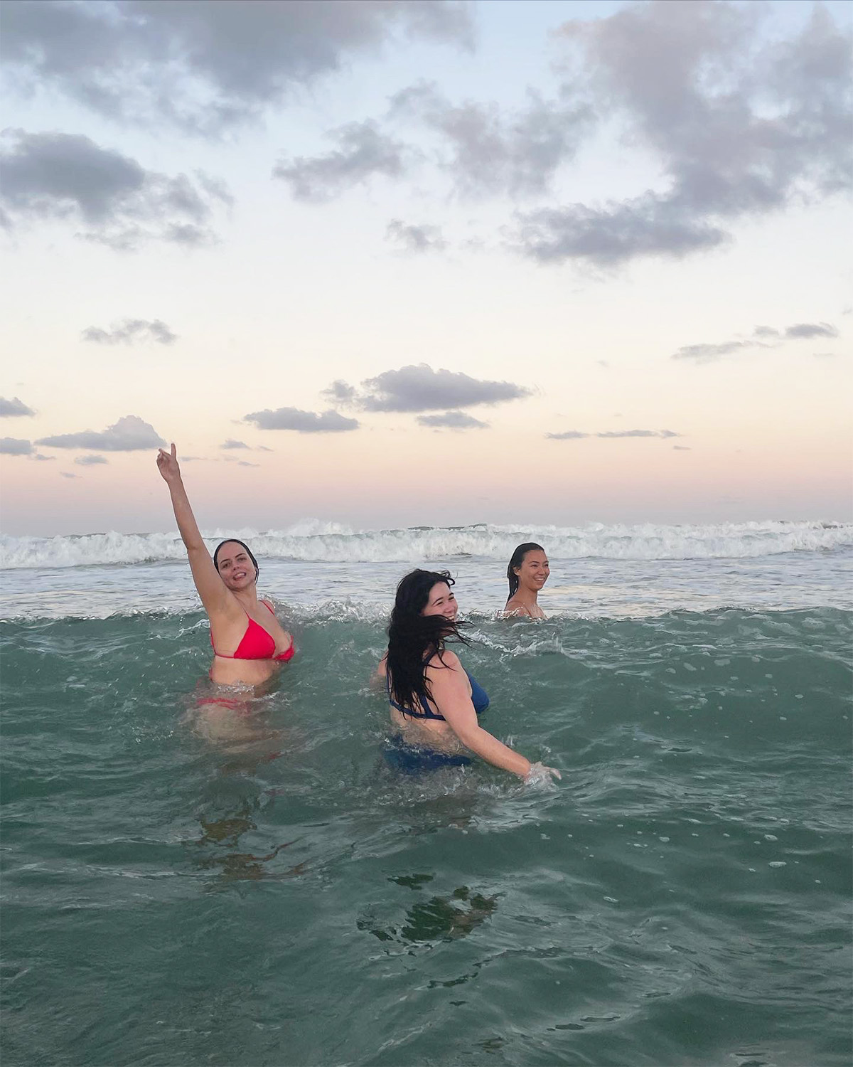 Three people in the ocean.
