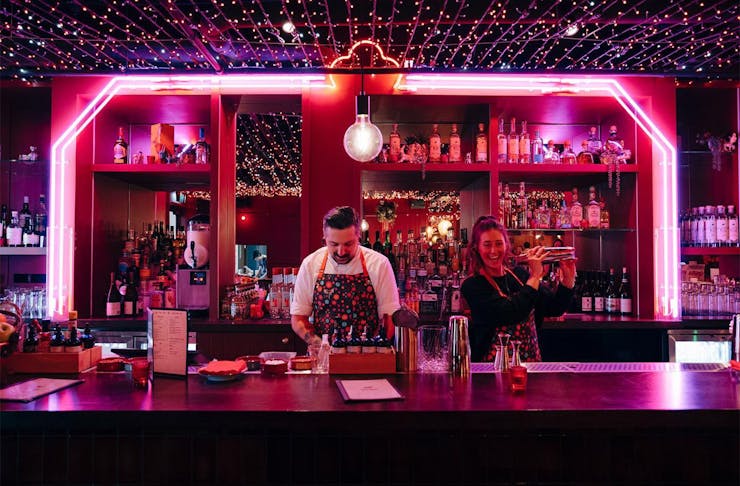 Bartenders shake up drinks at Ghost Donkey.