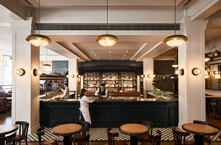 Gimlet's main bar adorned by two white pillars and filled with natural light.