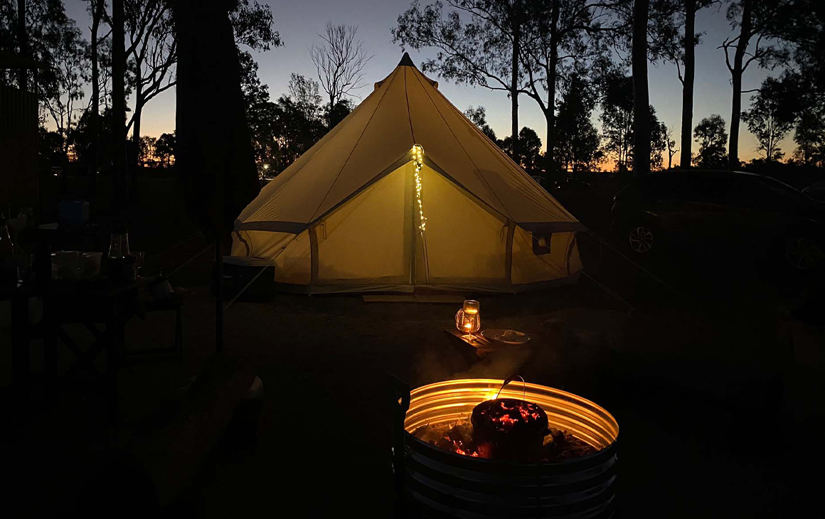 a canvas tent with a campfire
