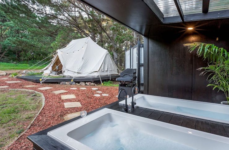 Two outdoor baths looking out onto a glamping tent in WA