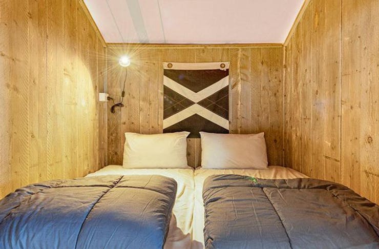 a double bed in a wooden nook