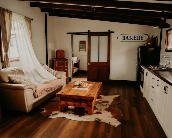 The living space with a cowhide rug at Old Glenroy Dairy one of the best farm stays near Brisbane
