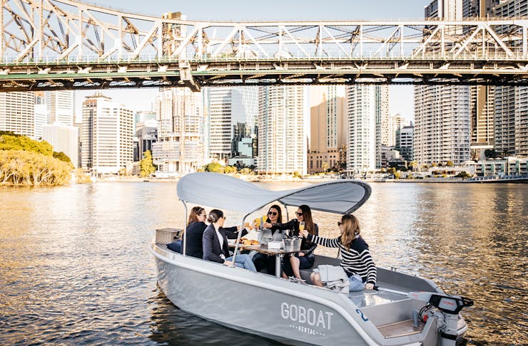 a small boat under the story bridge