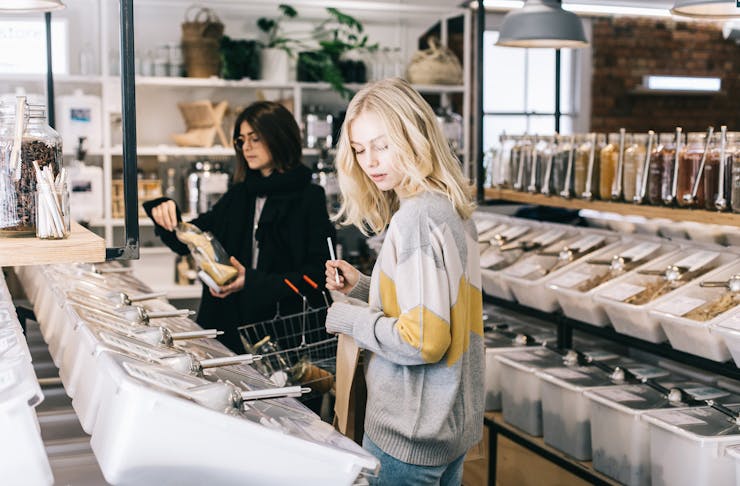 Two women shopping in modern bulk food store GoodFor.