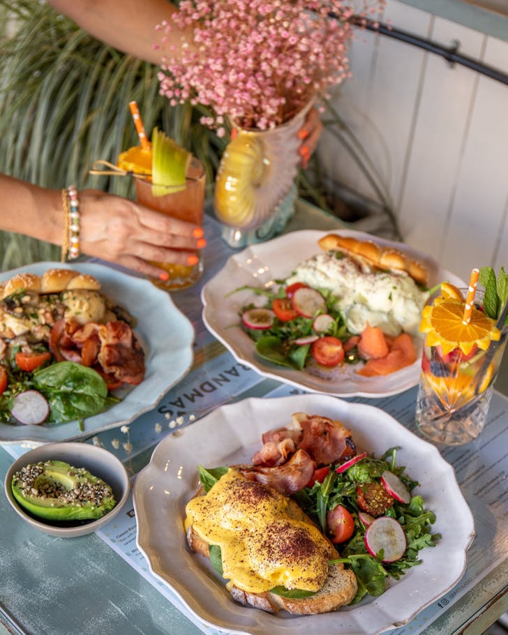 A well-styled table full of breakfast dishes and smoothies at Grandma's, Townsville.