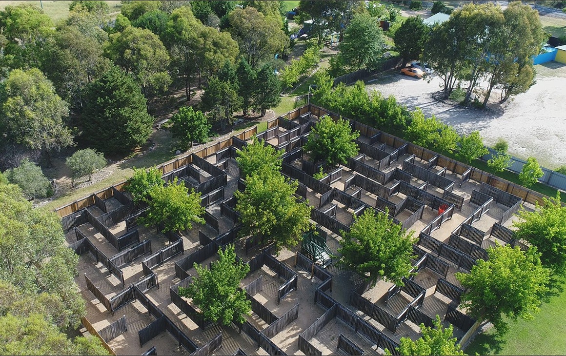 a larget wooden maze amongst trees