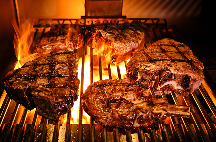 A Josper Grill with flames searing some of the best steak in Melbourne.