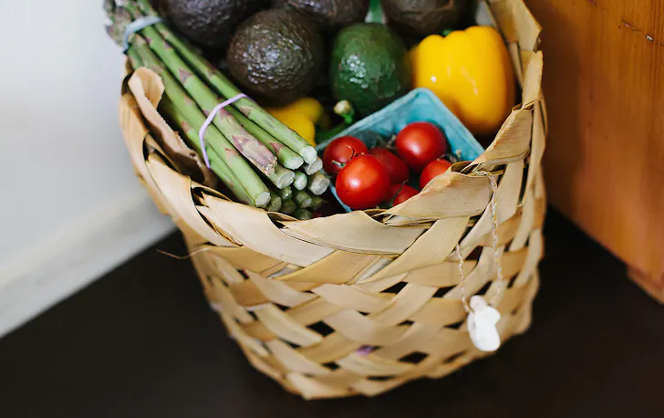 A basket of groceries by the door